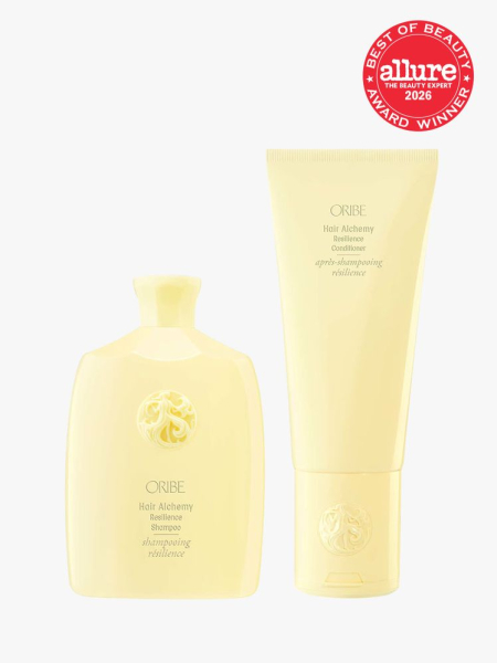 Oribe Hair Alchemy Resilience Shampoo & Conditioner yellow shampoo and conditioner bottles on light gray background with red Allure Best of Beauty seal in the top right corner