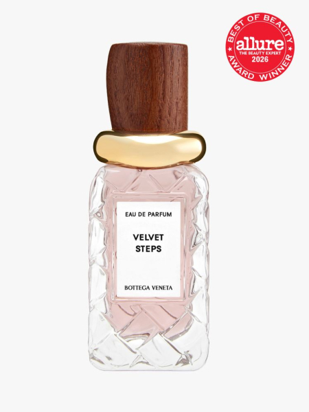 Clear bottle of Bottega Veneta Velvet Steps with wood and gold cap and an Allure Best of Beauty stamp in top right corner on a light gray background