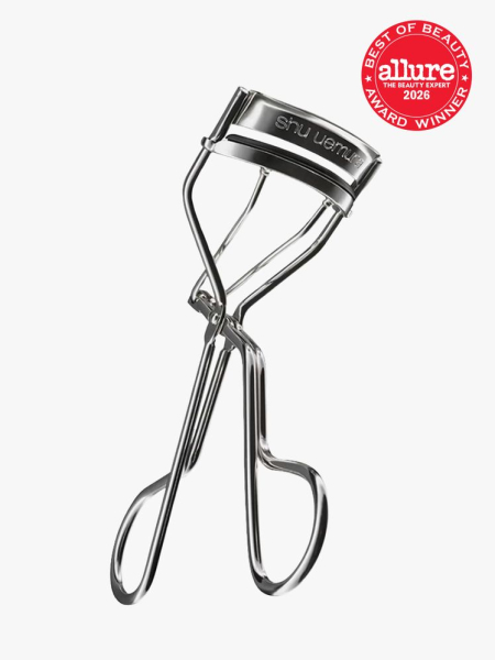 Shu Uemura Iconic Eyelash Curler in branded component on a light gray background with the 2026 best of beauty seal in the top right corner